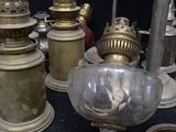 many different types of antique gas lamps on the table