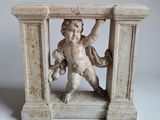 a small statue of a boy holding a teddy bear