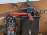 two toy figurines sitting on top of a wooden table