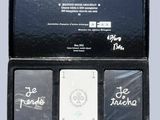 a black box with three cards in it that have writing on them