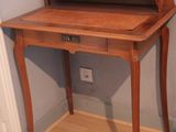 a wooden desk with a drawer on top of it