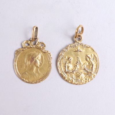 two gold coin pendants with the image of jesus and mary