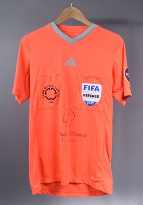 a close up of a shirt with a soccer jersey on a hanger