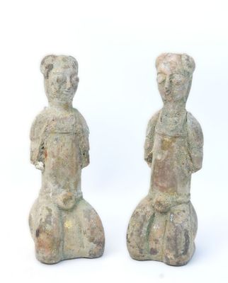 pair of ancient stone figurines of a man and a woman