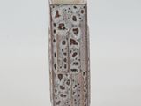 a small vase with holes in it on a white surface