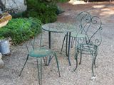 trois chaises et une table dans la zone recouverte de gravier