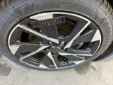 the tire of a car with a sticker on it ' s rim
