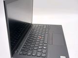 a black laptop with a red button on the keyboard