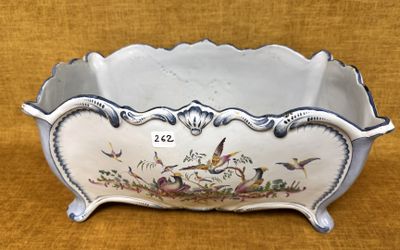 un bol blanc orné d'oiseaux, posé sur une table