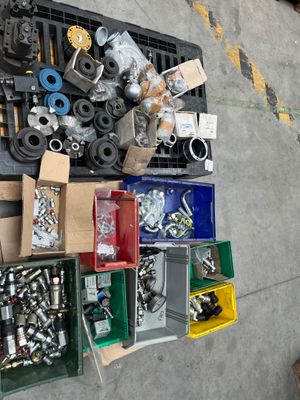 many different types of screws and nuts laid out on the floor