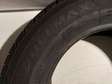 a close up of a tire on a white surface next to a white wall