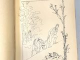 un livre ouvert sur lequel figure le dessin d'un homme et d'un chien