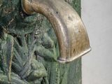 a close up of a door handle on a green door