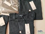 three sweaters and a bag of clothes on a table