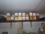 a shelf with boxes and boxes on it in a room