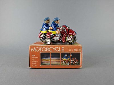 figurines of two people on a motorcycle on a box