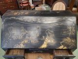 a black box with gold designs on it sitting on a table
