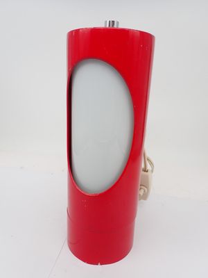 a red lamp that is on a white table