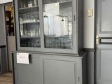 a cabinet with a glass door in the middle of the room