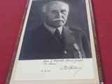 an old photo of a man in a military uniform on a red table