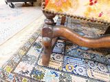 a chair that is sitting on a rug on the floor