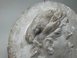 a statue of a woman with a bird on her head
