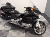 a black motorcycle that is parked on a checkered floor