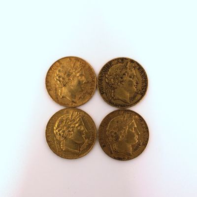 three gold coins with a portrait of a man and a woman on them
