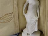 a figurine of a woman standing in a case