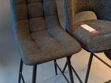 pair of grey chairs sitting next to each other on a white floor