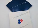 a close up of a book on a white surface with a blue cover