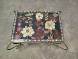 a tray with flowers painted on it on the floor