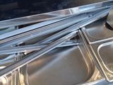 many trays of food that are sitting on the counter