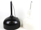 two black and white vases sitting next to each other
