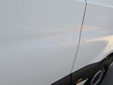 a white van that is parked on the side of the road