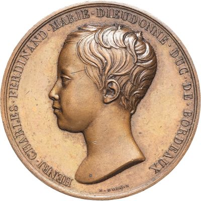 an old coin with a portrait of a young boy on it