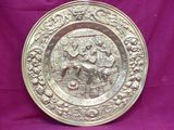 an old silver plate with a man and woman on it