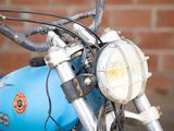 a close up of a motorcycle with a light on it ' s headlight