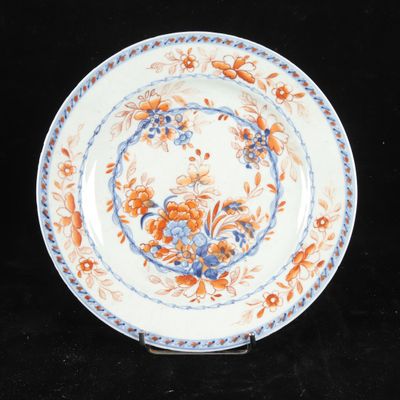 a close up of a plate with flowers on it on a black surface