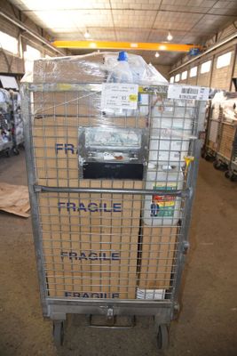 a metal cart with a sign on it in a warehouse