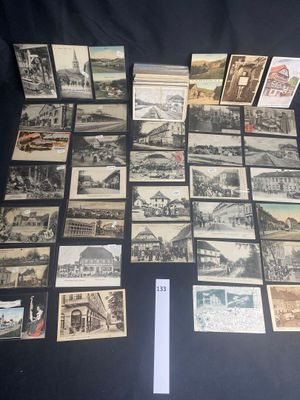 several old postcards of different types and sizes on a black surface