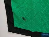 the back of a green and black shirt with a small black horse on it