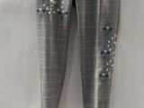 the pants have sequins on them and are hanging on a hanger