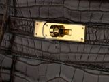 an image of a black purse with a gold lock