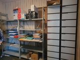 a man standing in the corner of a room with a book shelf