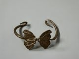 a close up of a metal cuff with a butterfly on it