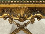 a gold bench with a green cushion on top of it