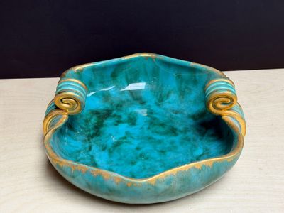 un bol bleu et or posé sur une table en bois
