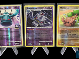 three different pokemon cards are shown in a row on a black background
