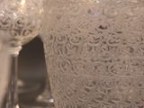 bottles and glasses are lined up on a table in a room